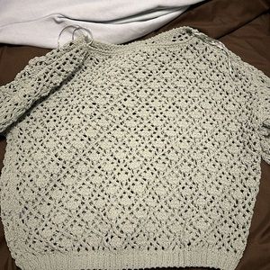 green sweater with holes